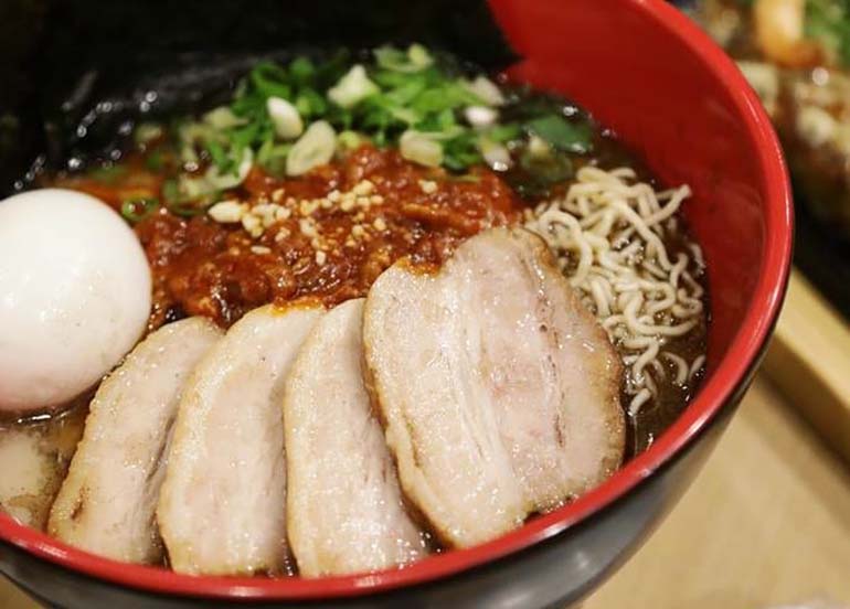 Ippudo Ramen topped with Chasu, chili, spring onions, and egg