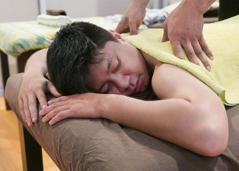 Boy taking back massage
