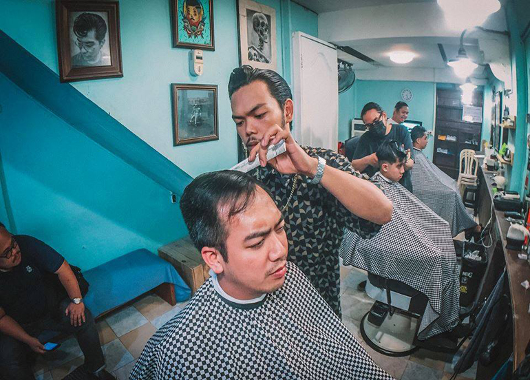 Slick Barbers Co. Interior with barber and client