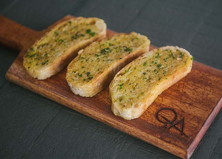 Ciabatta with Calabrian Chili Butter from Q & A Kitchen + Bar
