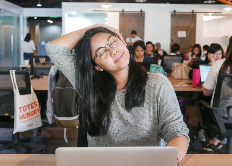 woman-stretching-neck-at-office