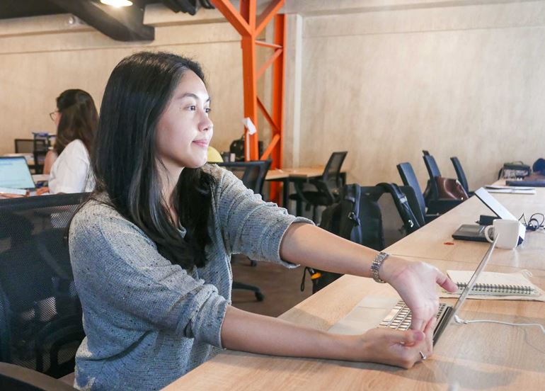 woman-stretching-fingers-at-desk