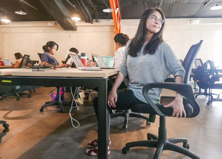 woman-stretching-back-in-chair