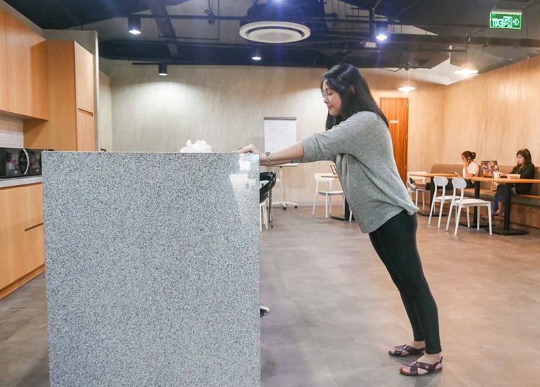 woman-leaning-on-counter-plank