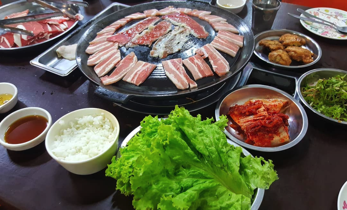 Display of meat assortments as well as side dishes and rice