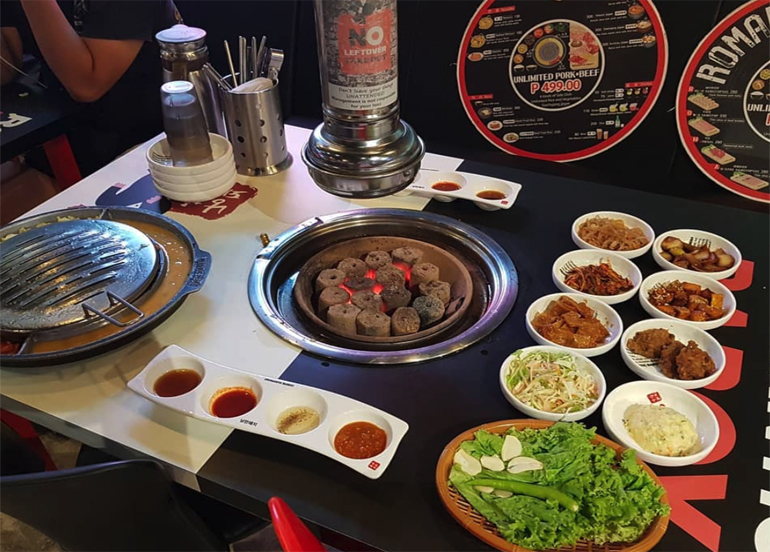 Side dishes on display with piping grill