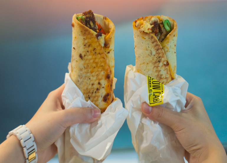 Hands holding Two MyWraps from Yellow Cab 