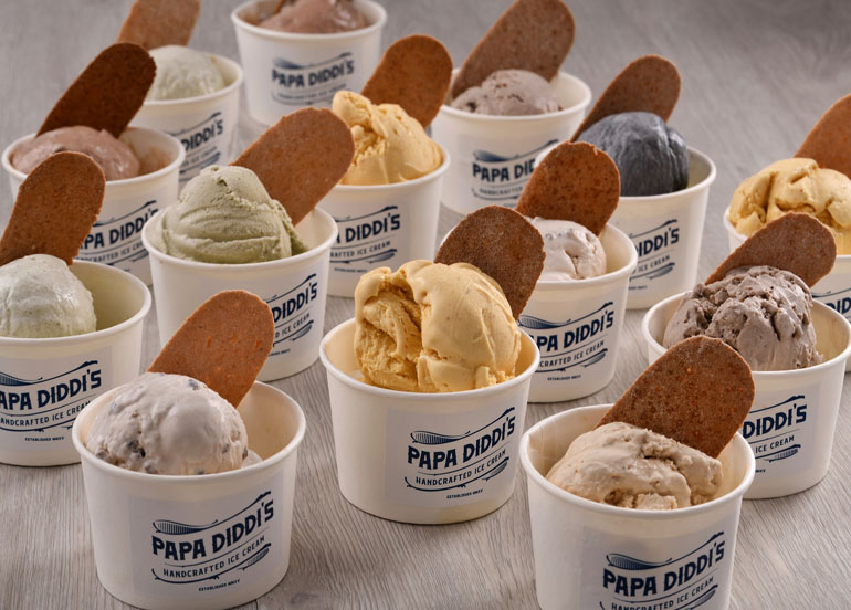 An assortment of Papa Diddi's handcrafted ice cream with lengua de gato on top