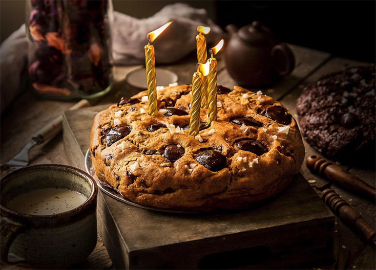 Ollie's Kitchen Celebration Chocolate Chip cookie cake topped with four candles