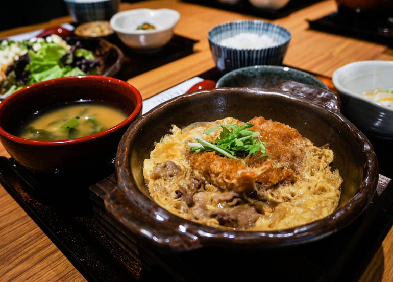Yayoi's teishoku meal served with a katsudon meal, miso soup, rice, and a side of salad