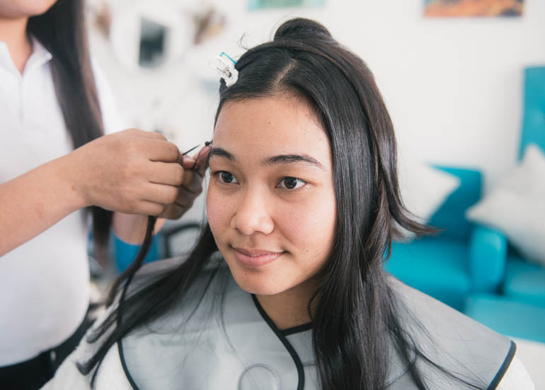 Client getting hair extensions from NS Beauty Salon 