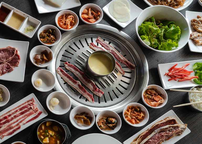 Gen Korean BBQ House featuring banchan, vegetables, meats, cheese, etc. 