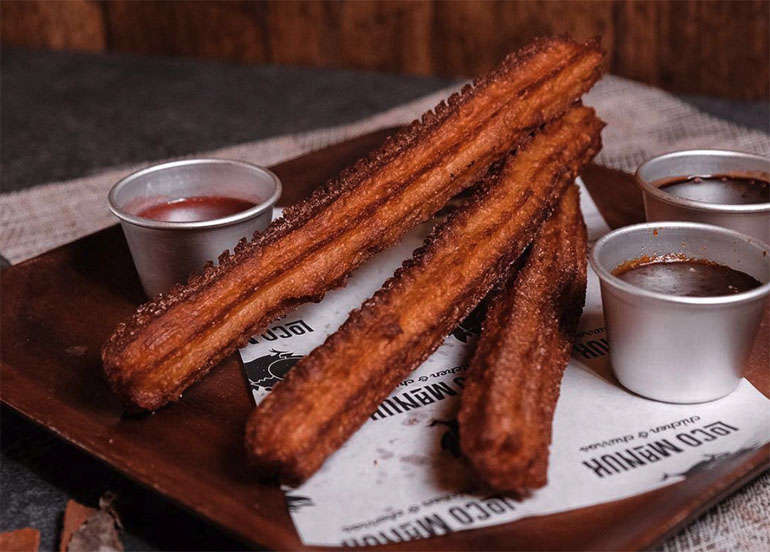 Churros with chocolate sauce on the side from Loco Manuk
