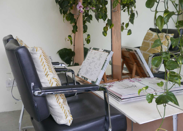 Benibana Beauty Hub Interior with Service menu, chairs, and decorative plants