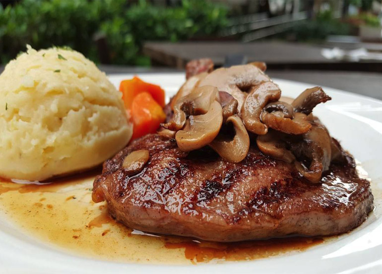 Steak from Mama Lou's topped with mushroom with a side of mashed potatoes