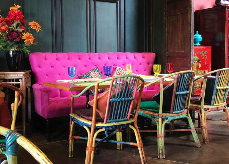 Cafe Voi La Interior with Pink Sofa and multi-colored chairs