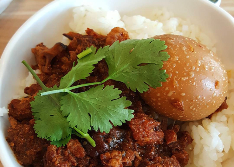 Braised beef from uniku topped with cilantro and egg