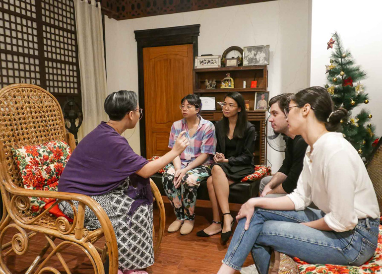 Tipsy Tales participants with Lola Mila in living room