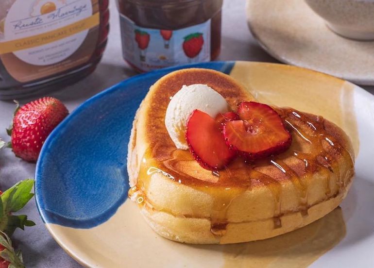 Heart-shaped waffle from Rustic Mornings topped with strawberries and butter